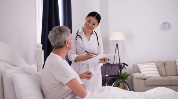 beautiful-nurse-doing-quick-check-up-on-patient-cheerful-friendly-asian-doctor-holding-clipboard-to-check-on-how-her-aged-patient-is-doing (1)